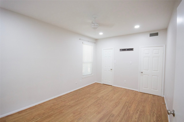 empty room with light hardwood / wood-style floors and ceiling fan