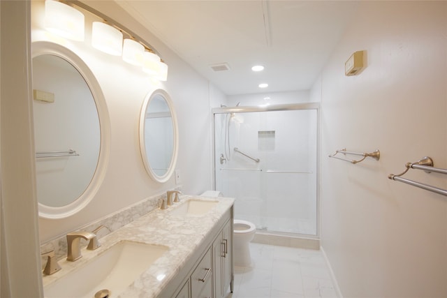 bathroom with vanity, toilet, and an enclosed shower