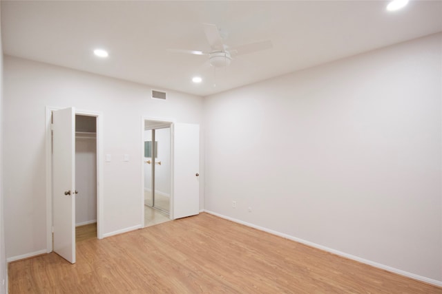 unfurnished bedroom featuring a closet, ceiling fan, and light hardwood / wood-style floors