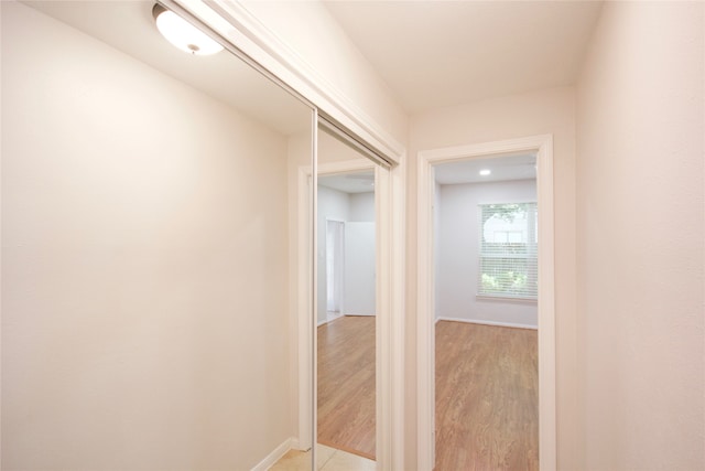 hallway with light hardwood / wood-style flooring