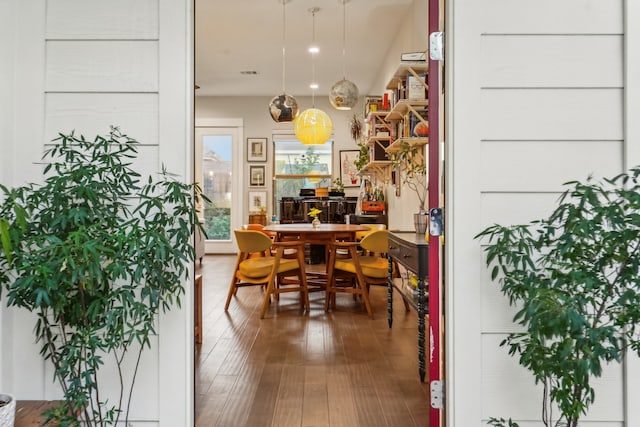 dining space with wood-type flooring