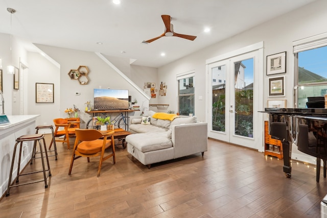 living room featuring ceiling fan, a healthy amount of sunlight, and wood-type flooring