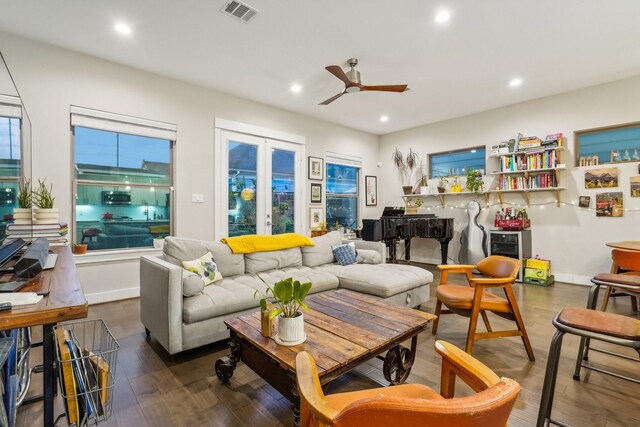 living room featuring ceiling fan, french doors, and dark hardwood / wood-style floors