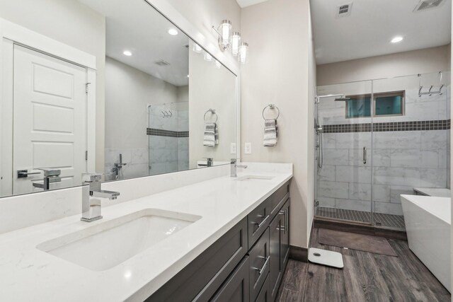 bathroom with vanity, shower with separate bathtub, and wood-type flooring