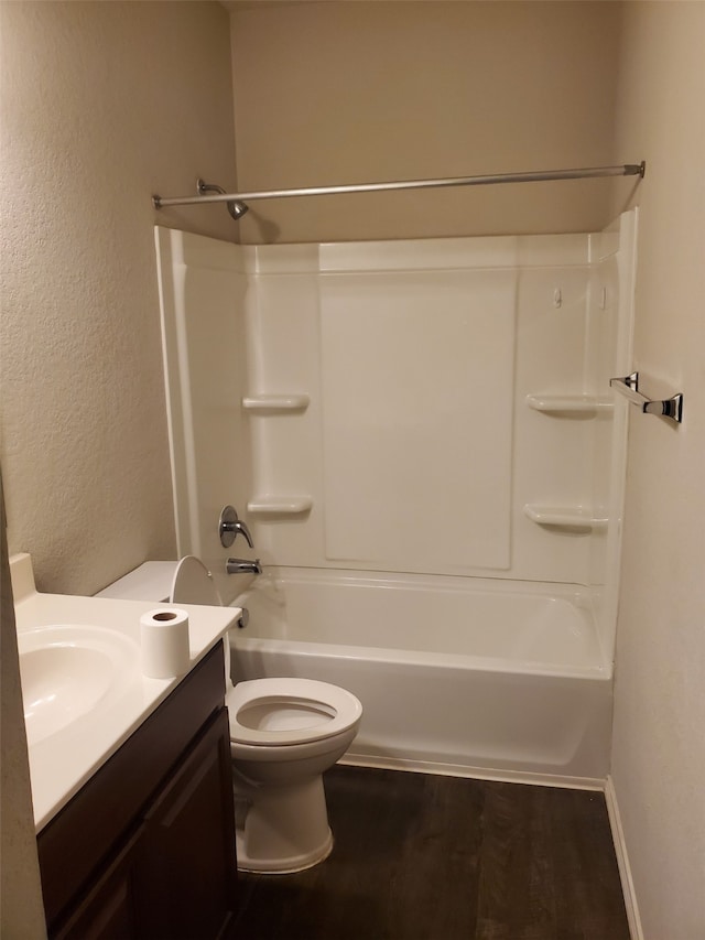 full bathroom featuring vanity, bathtub / shower combination, hardwood / wood-style flooring, and toilet