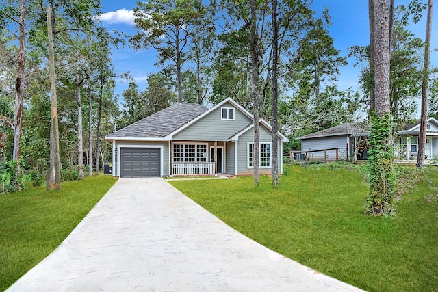 view of front of property with covered porch, a garage, and a front yard