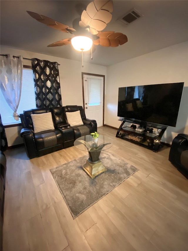 living room featuring ceiling fan and wood-type flooring