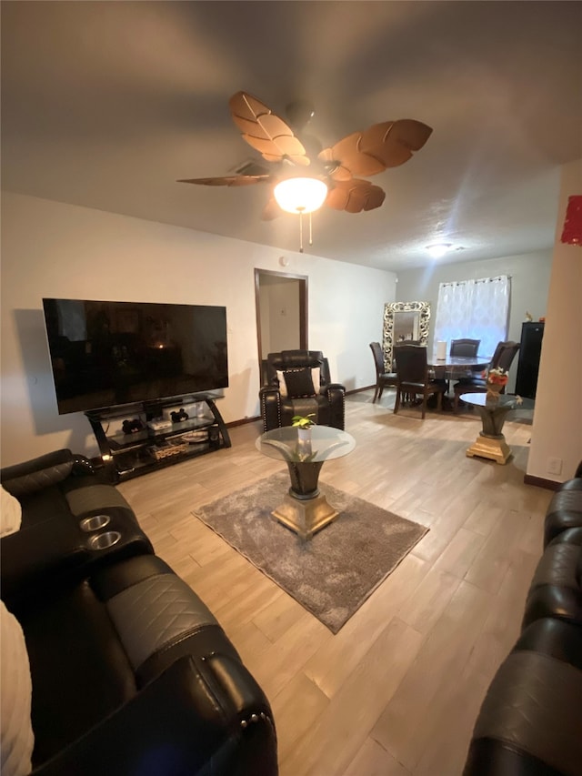 living room featuring ceiling fan and hardwood / wood-style flooring