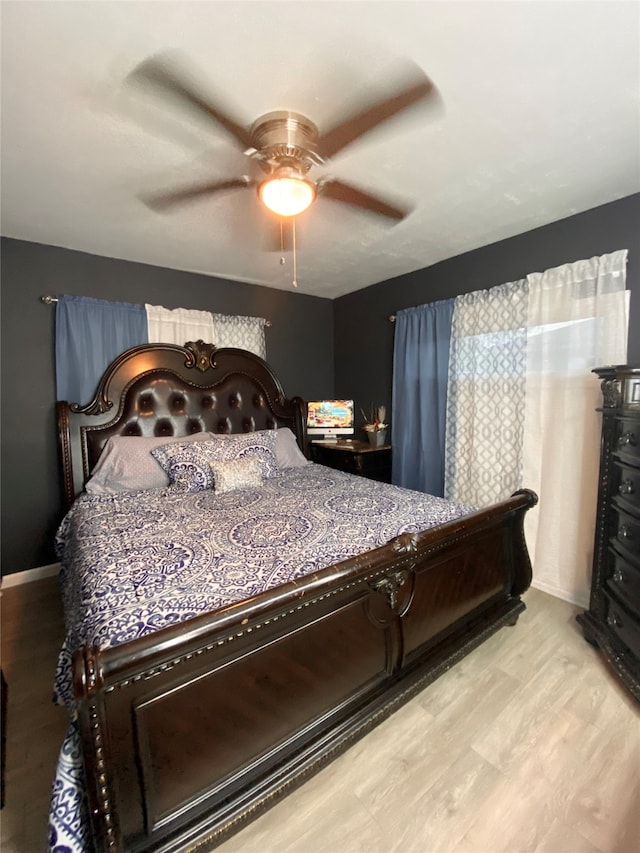 bedroom featuring ceiling fan and light hardwood / wood-style flooring