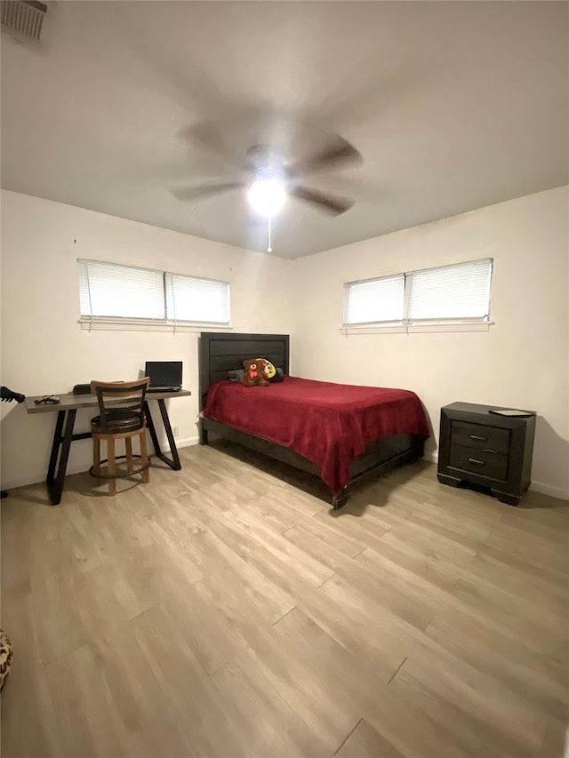 bedroom with light hardwood / wood-style flooring and ceiling fan