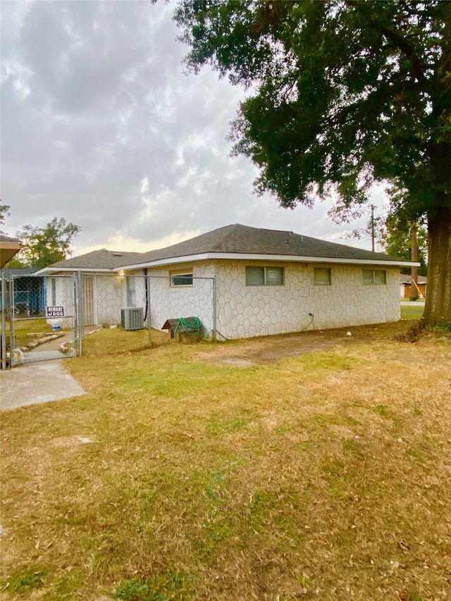 view of home's exterior with a yard, a patio, and central AC unit