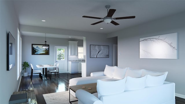 living room featuring ceiling fan and dark wood-type flooring