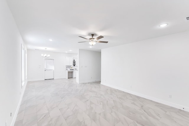 unfurnished living room with ceiling fan with notable chandelier