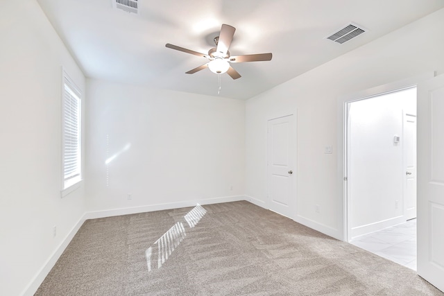 empty room featuring light carpet and ceiling fan