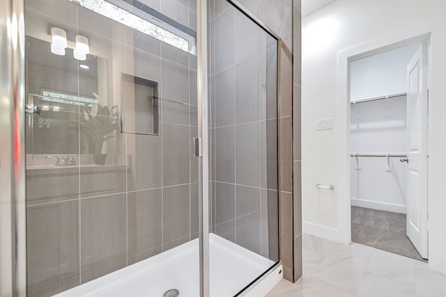 bathroom with a shower with door