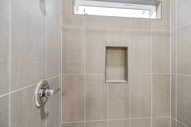 bathroom with tiled shower