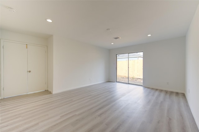 empty room with light hardwood / wood-style flooring