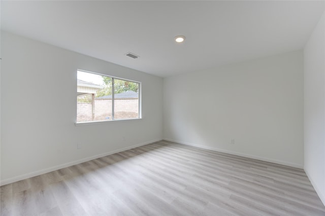 unfurnished room with light hardwood / wood-style flooring