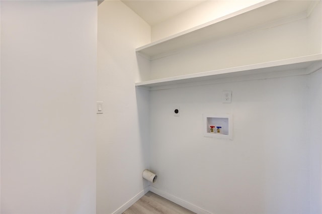 clothes washing area featuring hookup for a washing machine, electric dryer hookup, and light hardwood / wood-style floors