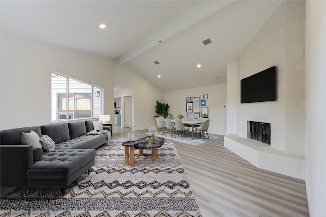 living room featuring high vaulted ceiling, hardwood / wood-style floors, and beam ceiling