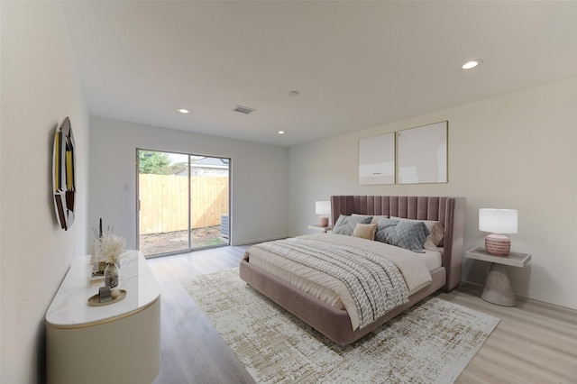 bedroom featuring access to exterior and light hardwood / wood-style flooring