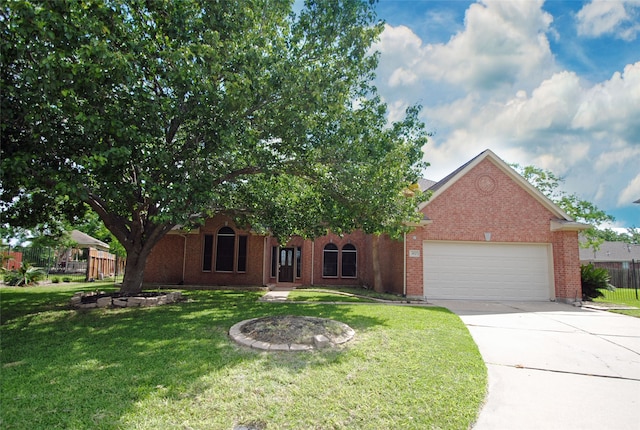 view of front of house with a front yard and a garage