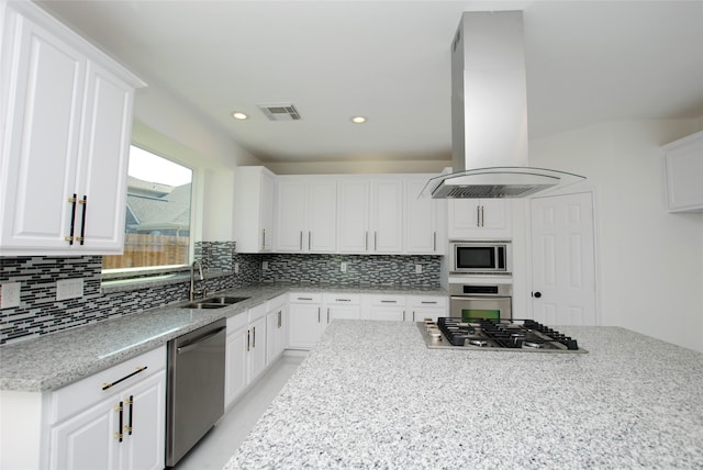 kitchen with appliances with stainless steel finishes, white cabinetry, sink, and island range hood