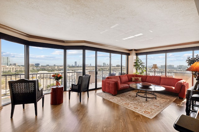 living room with ornamental molding, hardwood / wood-style floors, and a textured ceiling