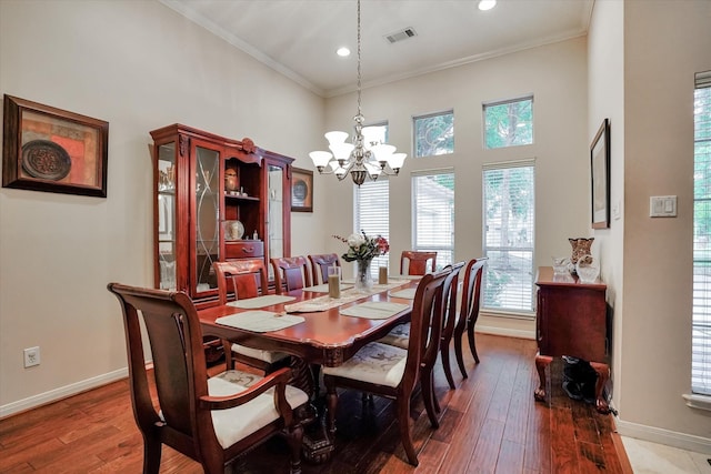 15420 Winterhaven Dr, Tomball, TX 77377 - dining room featuring a chandelier, baseboards, ornamental molding, wood-type flooring, and a high ceiling