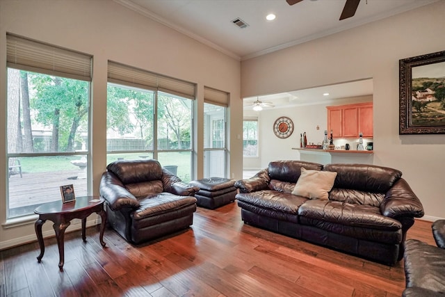 living room with ceiling fan, hardwood / wood-style flooring, and crown molding