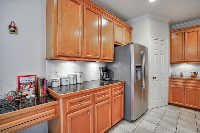 kitchen featuring backsplash, light tile patterned flooring, ornamental molding, and stainless steel fridge with ice dispenser