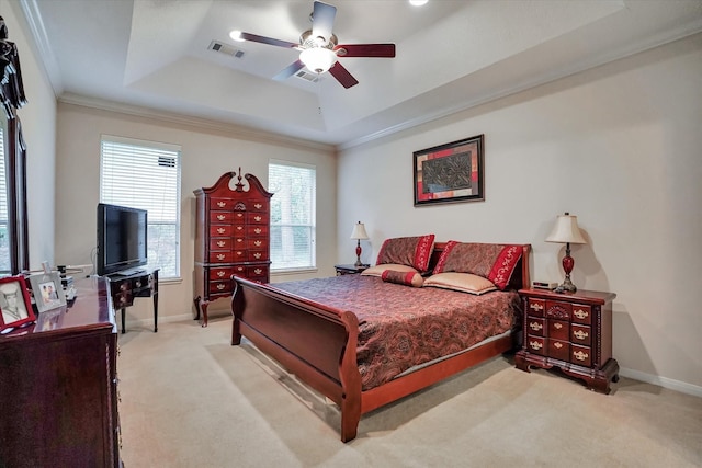 bedroom featuring ceiling fan, light carpet, ornamental molding, and a tray ceiling