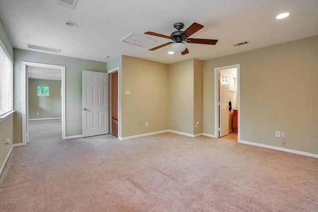 unfurnished bedroom with connected bathroom, ceiling fan, and light carpet