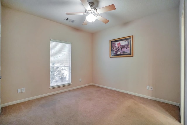 empty room featuring light colored carpet and ceiling fan