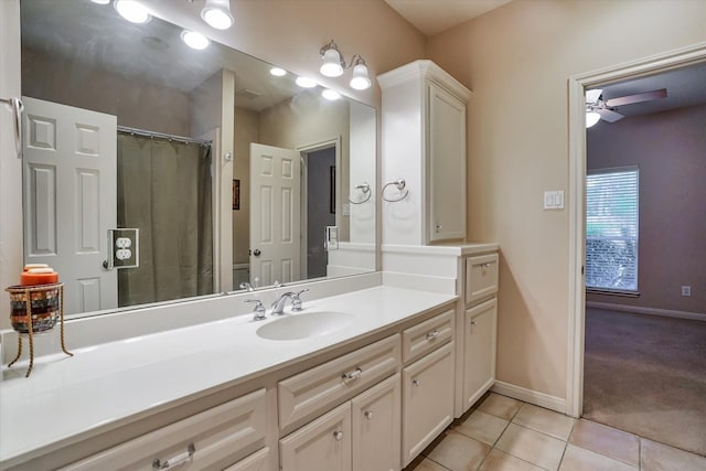 15420 Winterhaven Dr, Tomball, TX 77377 - bathroom with tile patterned floors, ceiling fan, baseboards, and vanity