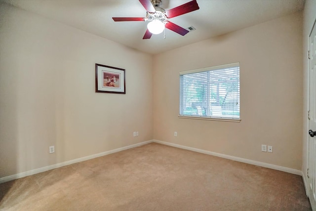 carpeted spare room with ceiling fan