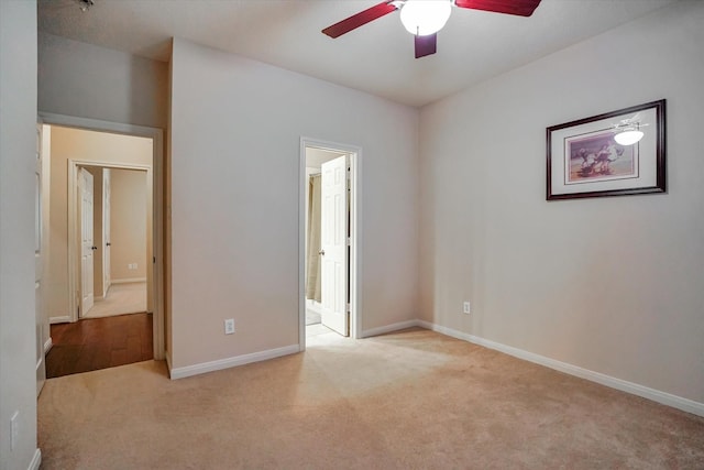 unfurnished bedroom featuring light carpet and ceiling fan