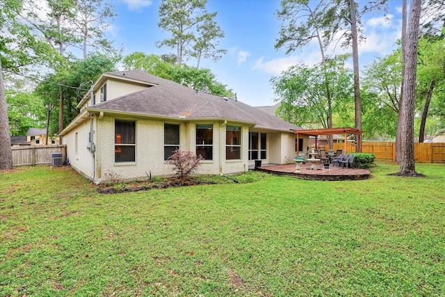 rear view of house featuring a patio area, central AC, and a lawn