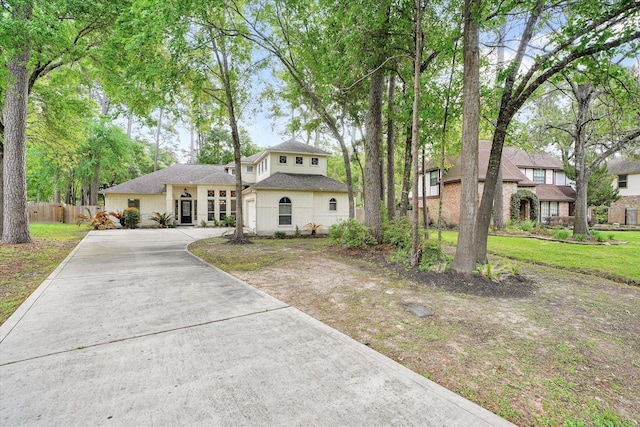 15420 Winterhaven Dr, Tomball, TX 77377 - view of front of house featuring fence, concrete driveway, roof with shingles, and brick siding