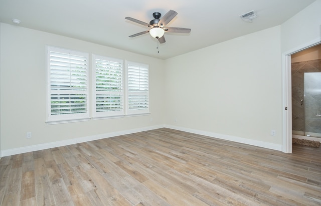 unfurnished room with light wood-type flooring and ceiling fan