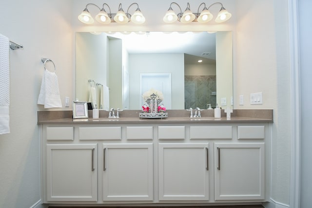 bathroom featuring vanity and an enclosed shower