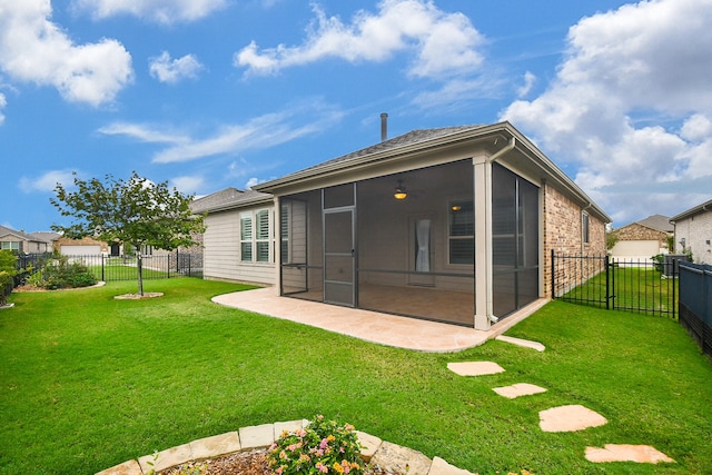 back of house featuring a yard, a sunroom, and a patio