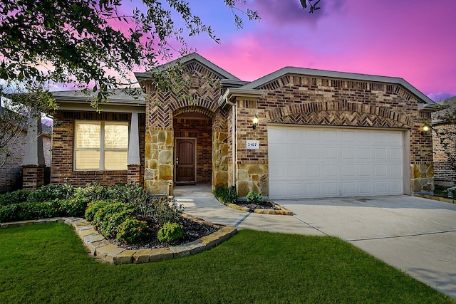 view of front facade with a yard and a garage