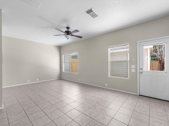 tiled foyer featuring ceiling fan and a textured ceiling