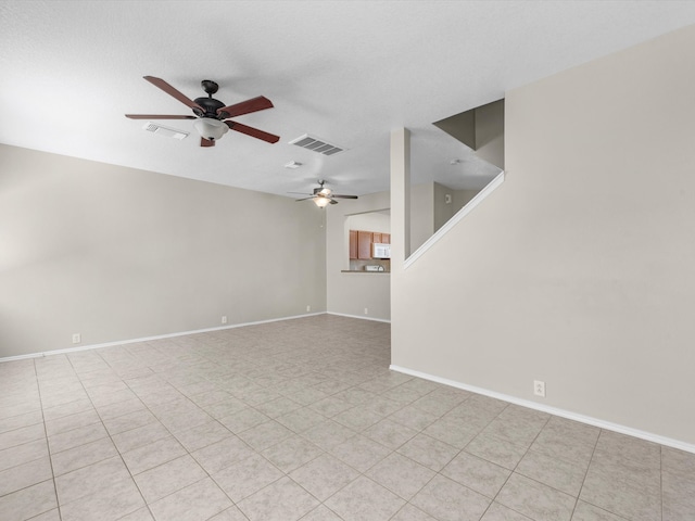 spare room with a textured ceiling and ceiling fan