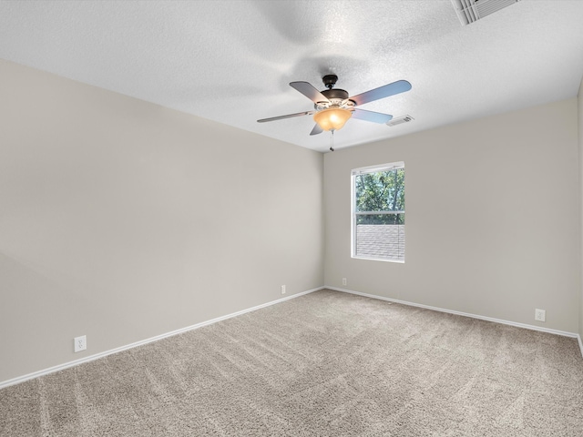 empty room with a textured ceiling, carpet flooring, and ceiling fan