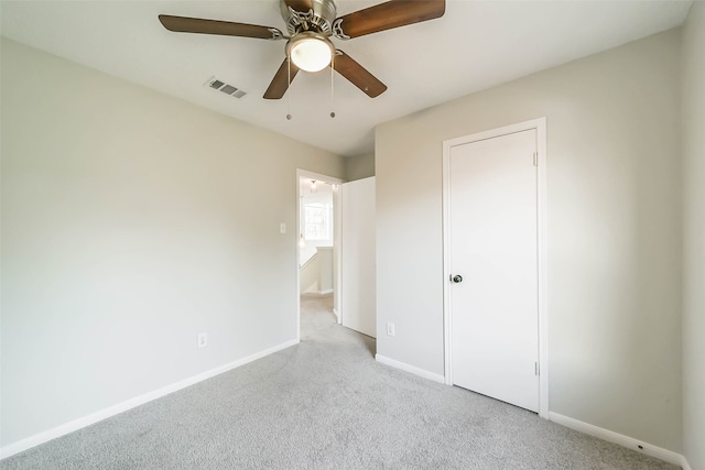 unfurnished bedroom with light colored carpet and ceiling fan