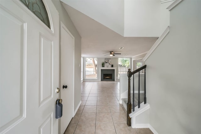 entryway with ceiling fan and light tile patterned flooring