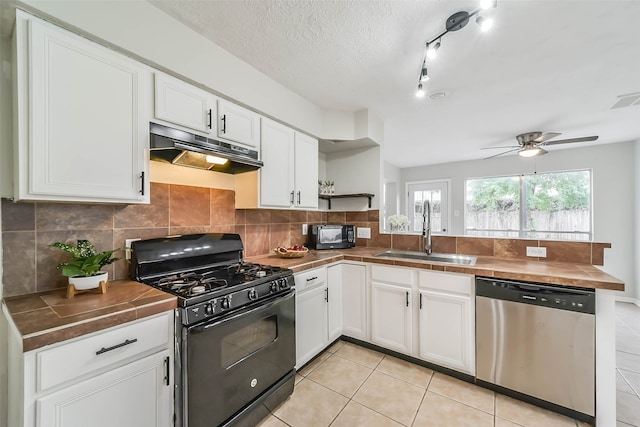 kitchen featuring tile countertops, white cabinetry, a textured ceiling, black appliances, and sink