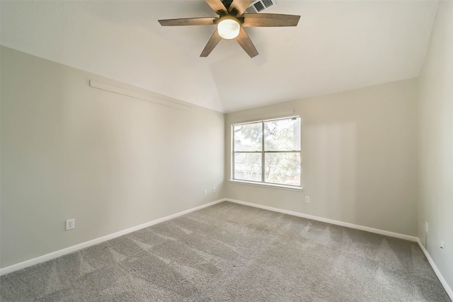 empty room featuring vaulted ceiling, carpet flooring, and ceiling fan